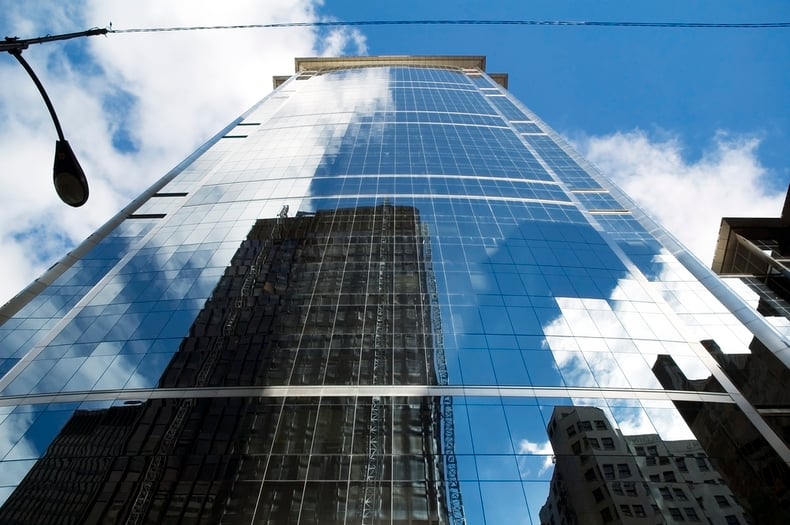 Modern commercial office buildings against blue sky representing the 2026 commercial property insurance market outlook